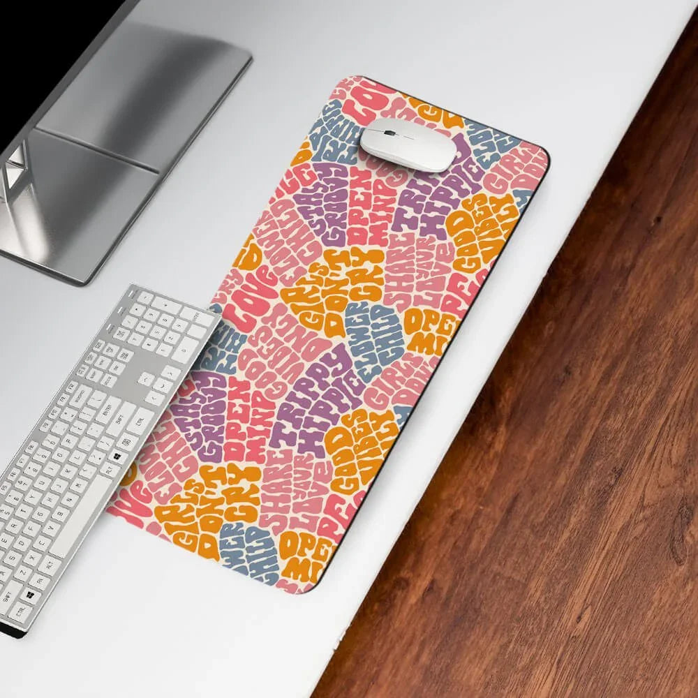 Colorful desk mat with psychedelic text design under keyboard and mouse on white desk