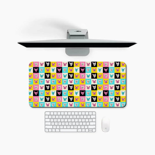 Colorful cat face pattern desk mat on a white desk with keyboard and mouse