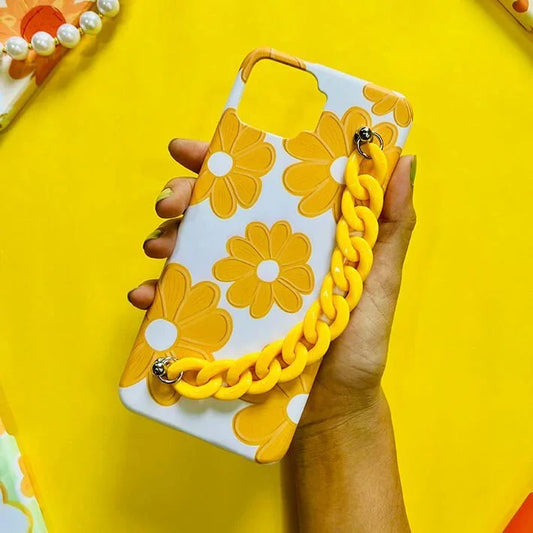 Yellow floral chain phone case held in hand, bold daisy design, trendy accessory