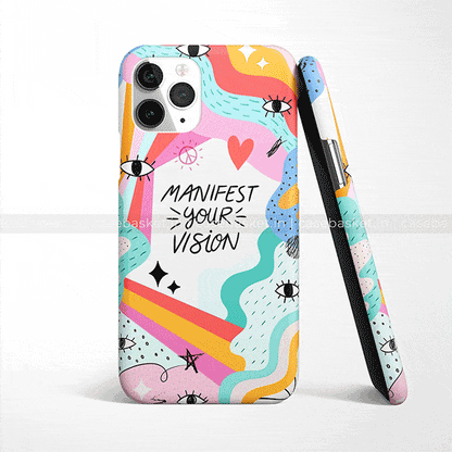 Colorful abstract phone case with eyes, hearts, peace symbols, and 'Manifest Your Vision' text
