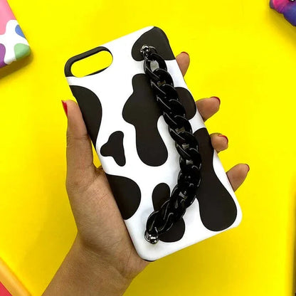 Black and white cow print phone case with black chain charm handle held in hand