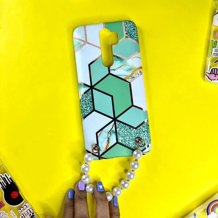 Mint green geometric phone case with gold accents and pearl chain handle on yellow background.