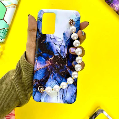 Blue marble design phone case with pearl chain charm held in hand, yellow background