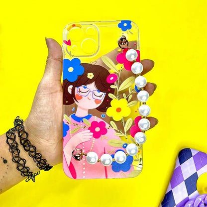 Cute girl cartoon floral phone case with pearl chain charm, held in hand on yellow background
