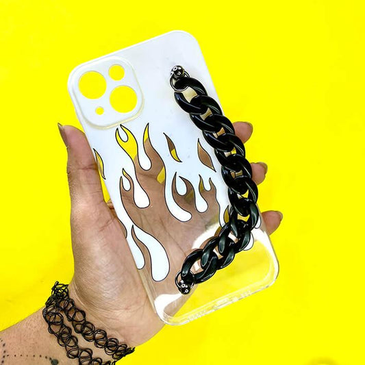 Transparent flame phone case with black chain handle, held against yellow background