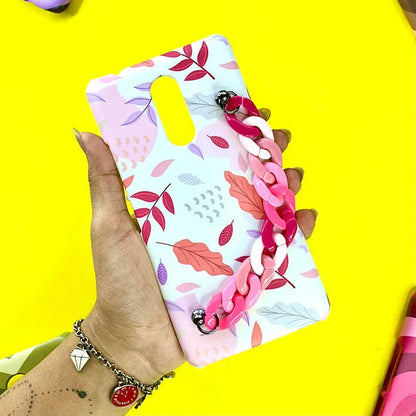 Floral leaf print phone case with pink chain strap, held in hand on yellow background.