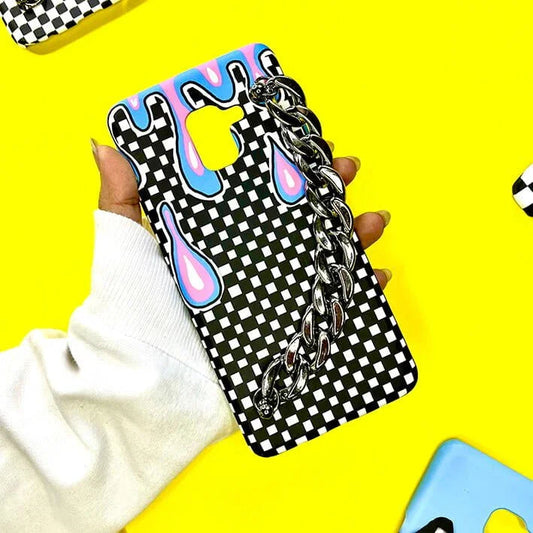 Checkered phone cover with chain handle and colorful drips, held on yellow background