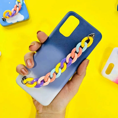 Blue gradient phone case with colorful plastic chain charm, held in hand on yellow background