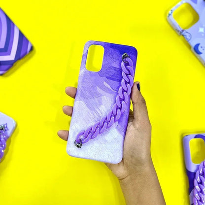 Hand holding a purple marble phone case with a chunky chain handle, yellow background, trendy mobile cover