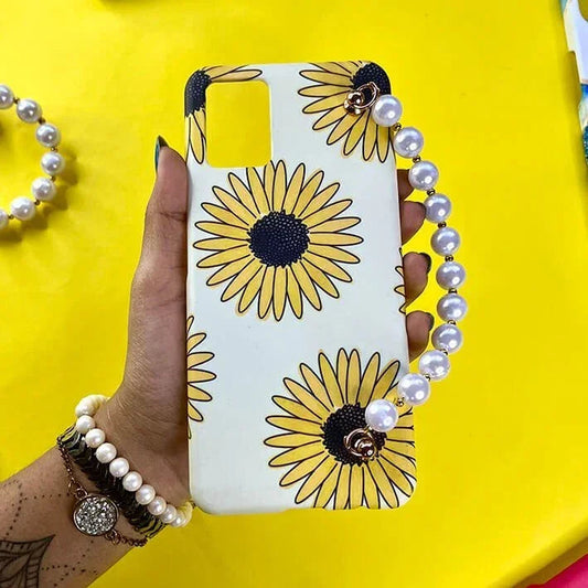 Sunflower print phone case with pearl chain charm, held in hand, yellow background