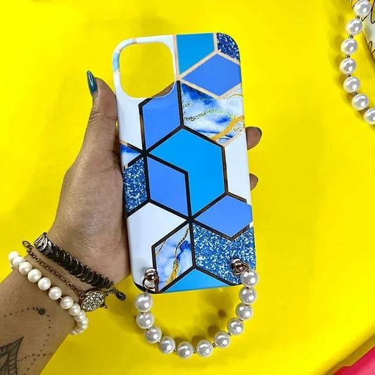 Blue geometric marble phone case with pearl chain handle held in hand on yellow background
