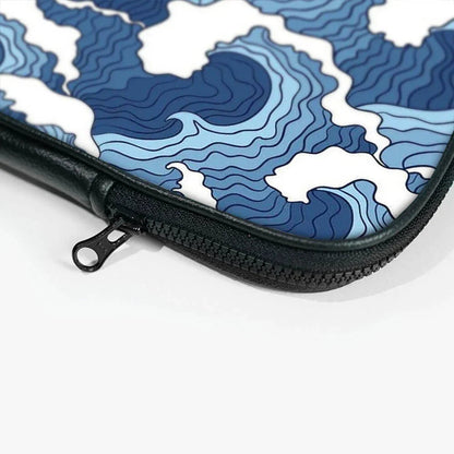 Close-up of a laptop sleeve with blue abstract wave pattern and black zipper