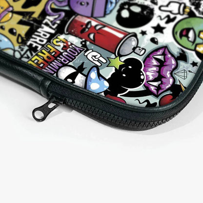 Close-up of a colorful cartoon graphic laptop sleeve with zipper, featuring graffiti art design