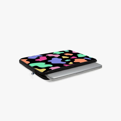Colorful abstract pattern laptop sleeve with zipper, partially open with a silver laptop inside.