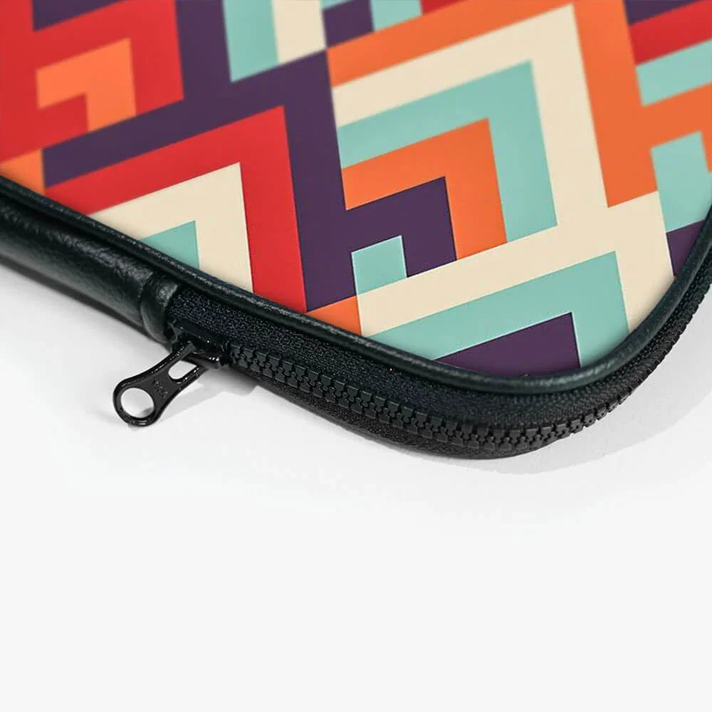 Colorful geometric pattern laptop sleeve with black zipper close-up