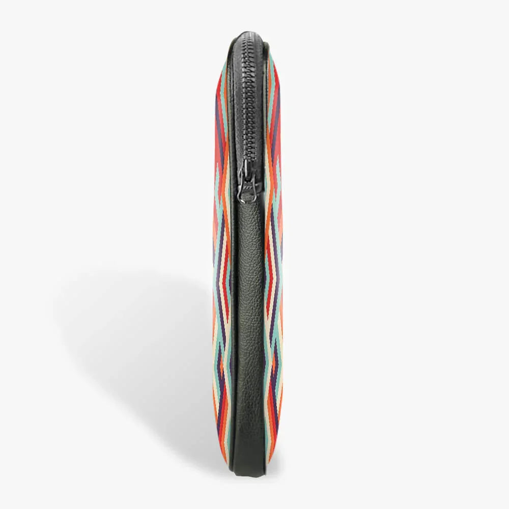 Slim black laptop sleeve with colorful geometric pattern and zippered closure, side view
