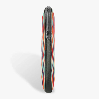 Slim black laptop sleeve with colorful geometric pattern and zippered closure, side view