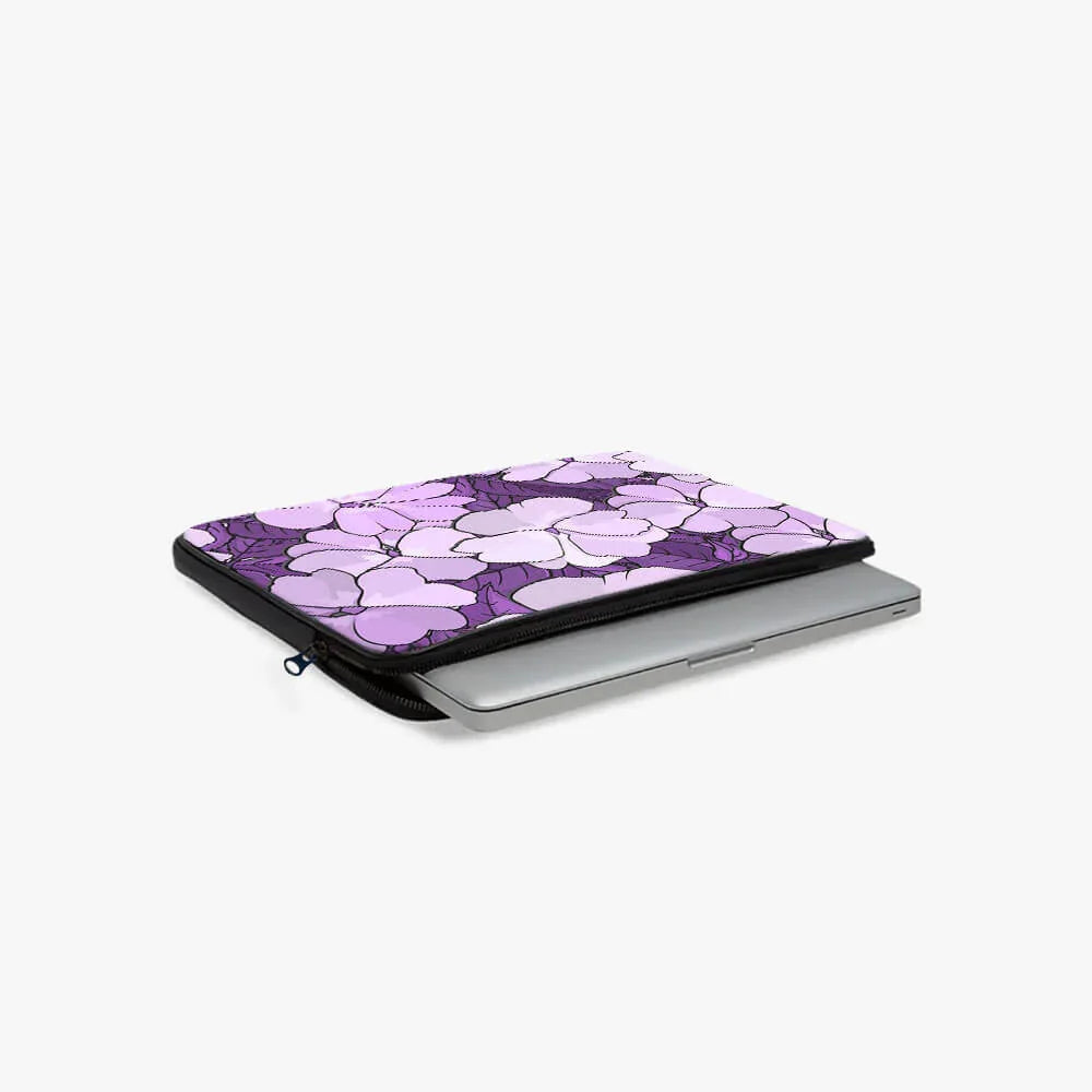 Purple floral laptop sleeve with zipper and 13-inch laptop on white background