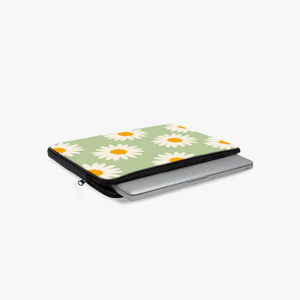 Green floral laptop sleeve with white daisy print, partially open with laptop inside