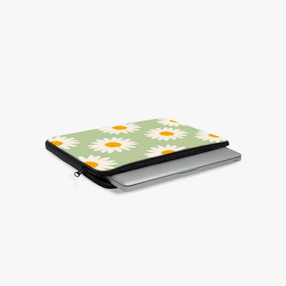 Green floral laptop sleeve with white daisy print, partially open with laptop inside