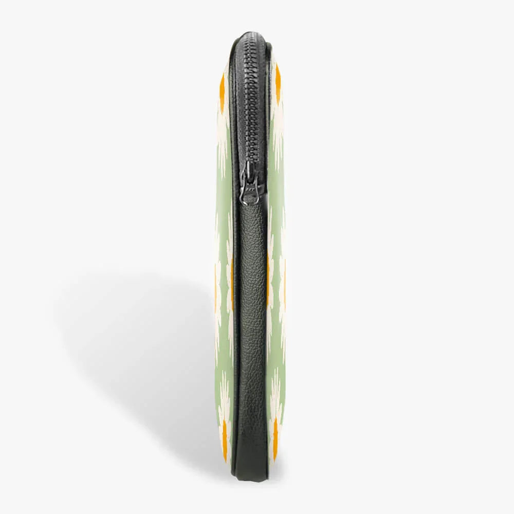 Side view of slim floral laptop sleeve with zipper and green daisy pattern