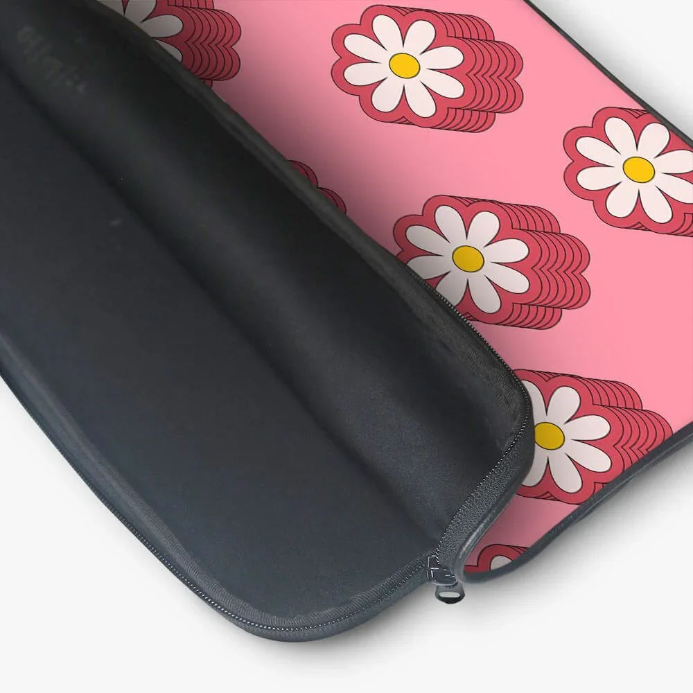 Pink laptop sleeve with white daisy floral pattern and black zippered interior
