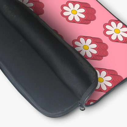 Pink laptop sleeve with white daisy floral pattern and black zippered interior