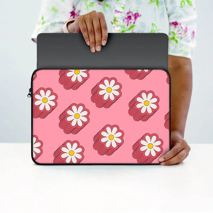 Person holding laptop sleeve with pink background and white daisy flower pattern