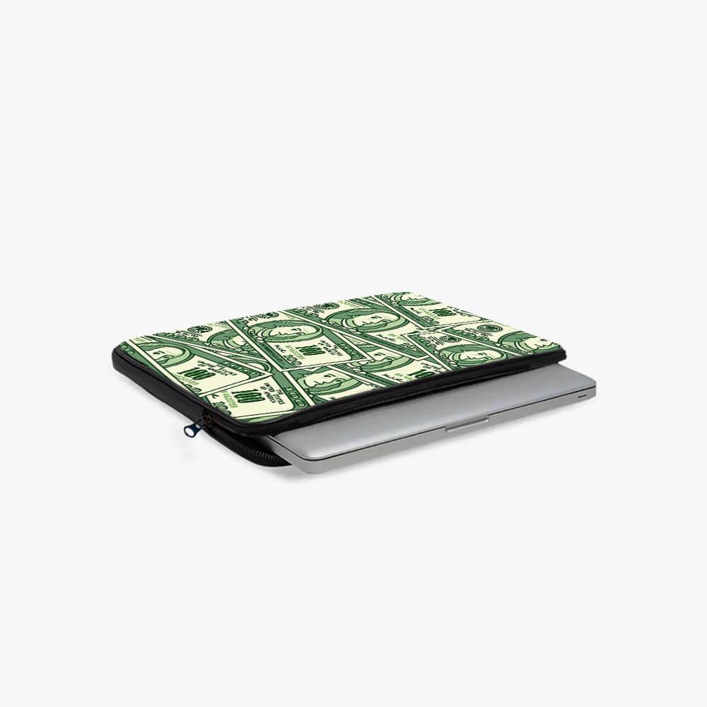 Laptop sleeve with green dollar bill print and zipper, holding a silver laptop on white background