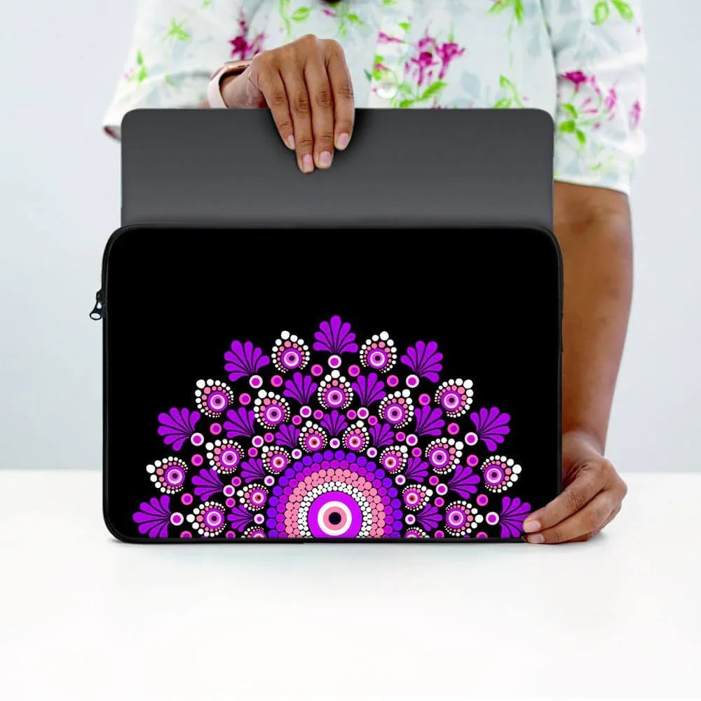 Black laptop sleeve with vibrant purple and pink mandala design, person inserting laptop