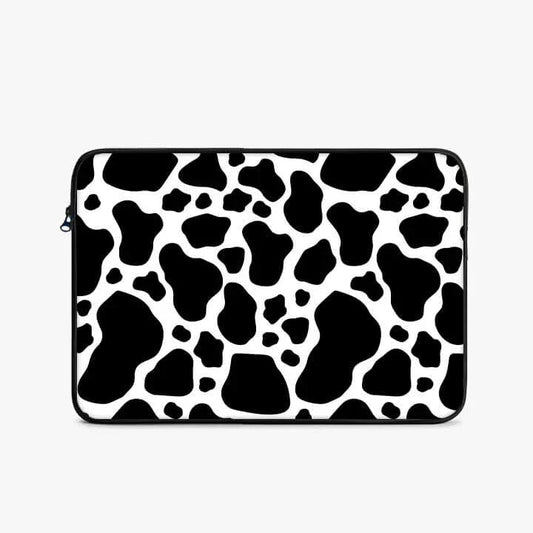 13-inch laptop sleeve with black and white cow print pattern, zipper closure, minimalist style