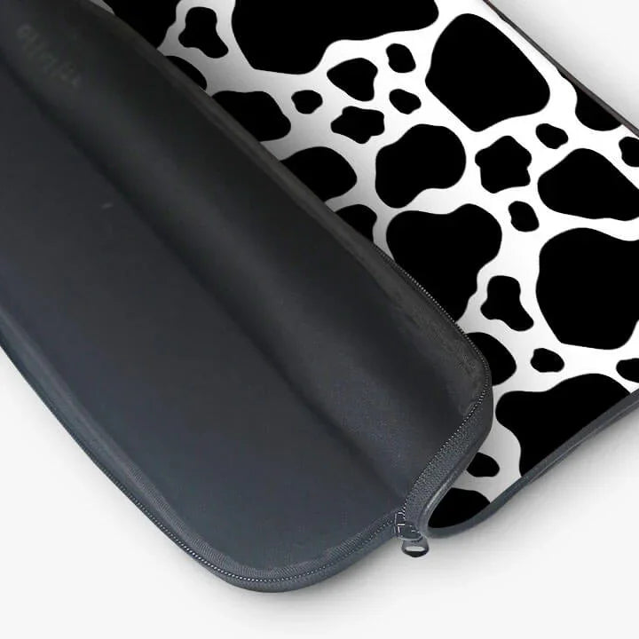 Black and white cow print laptop sleeve with zippered pouch, modern sleeve design