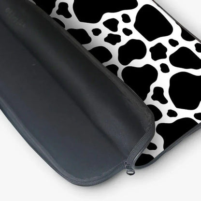 Black and white cow print laptop sleeve with zippered pouch, modern sleeve design