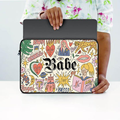 Colorful 13-inch laptop sleeve with doodle art and 'Babe' text, held by person in floral shirt