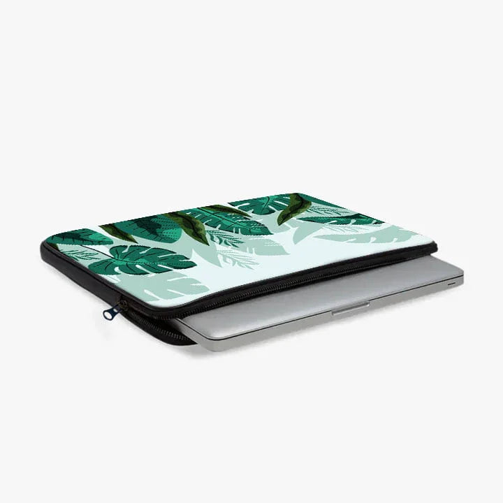 13-inch laptop sleeve with green tropical leaf print, partially unzipped showing laptop