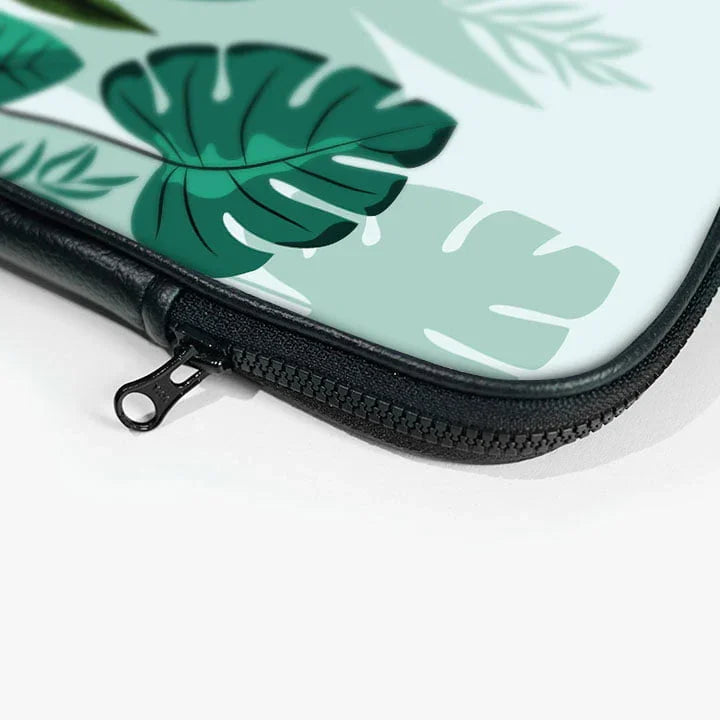 Close-up of a laptop sleeve with green leaf design and black zipper pouch