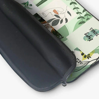 13-inch laptop sleeve with zipper pouch, featuring a green abstract leaf and face design