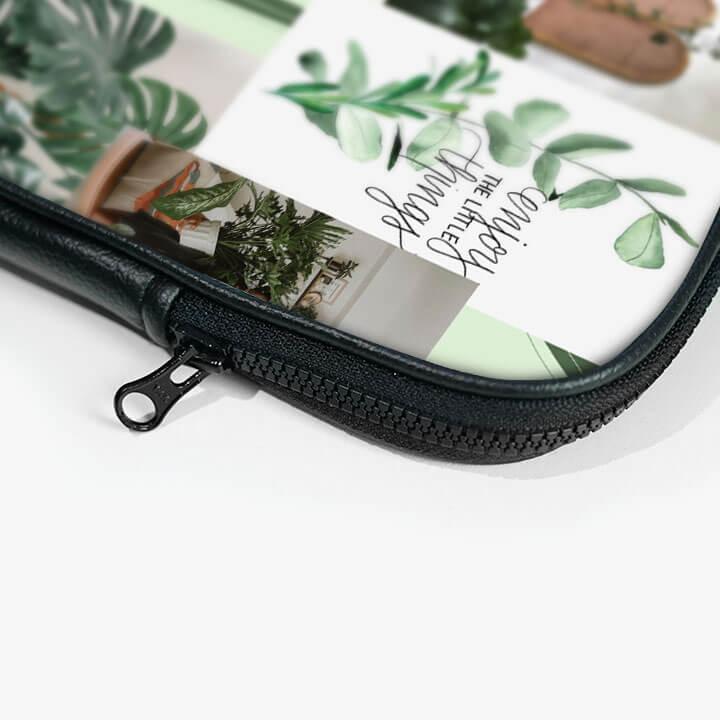 Close-up of a 13-inch laptop sleeve zip pouch with green plant print and black zipper