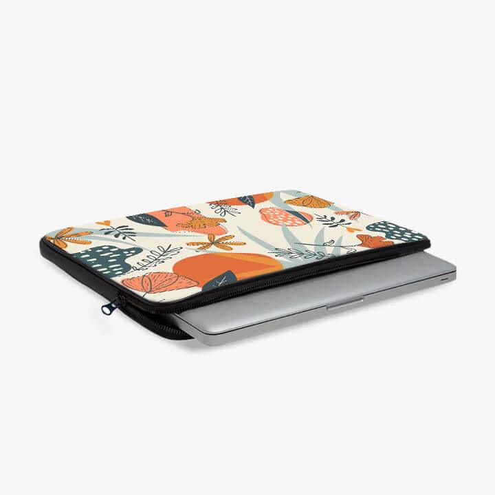 13-inch laptop sleeve with zipper and colorful abstract floral design, laptop partially inside