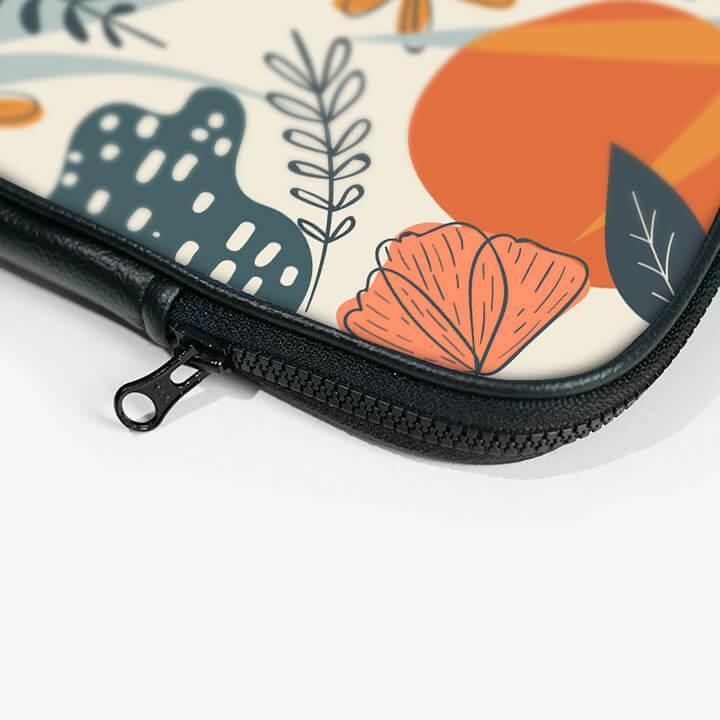 Close-up of 13-inch laptop sleeve with colorful floral pattern and black zipper