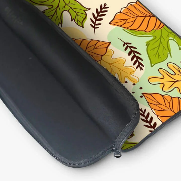 Open laptop sleeve with colorful autumn leaf pattern and secure zipper closure.
