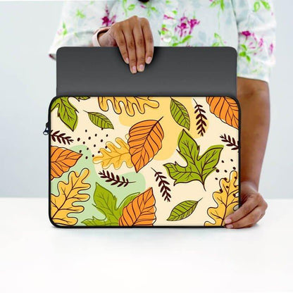 13-inch laptop sleeve with colorful autumn leaf pattern held on white table