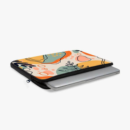 Colorful abstract print laptop sleeve with zipper, holding a silver laptop on white background.