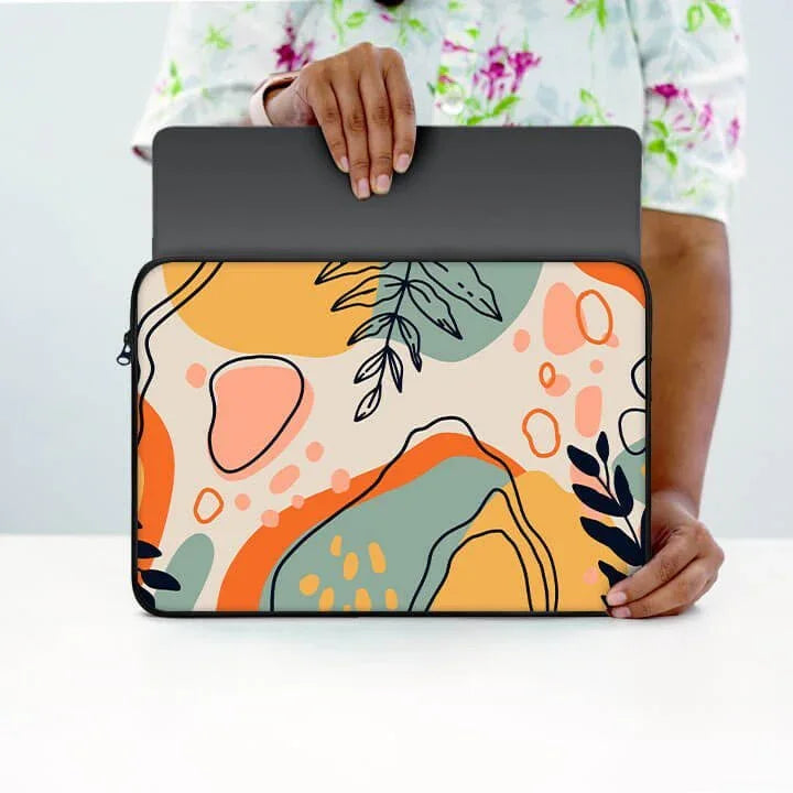 Colorful abstract floral laptop sleeve with zipper, held by person, 13-inch size