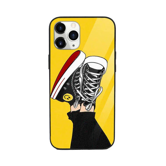 Yellow pop art phone case with illustrated black sneakers and smiley face design
