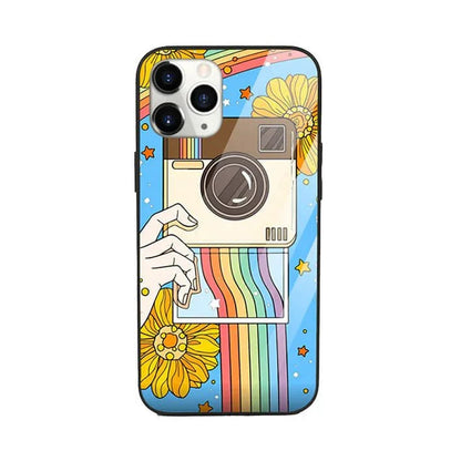 Pop art phone case with camera, rainbow stripes, sunflowers, and stars on blue background