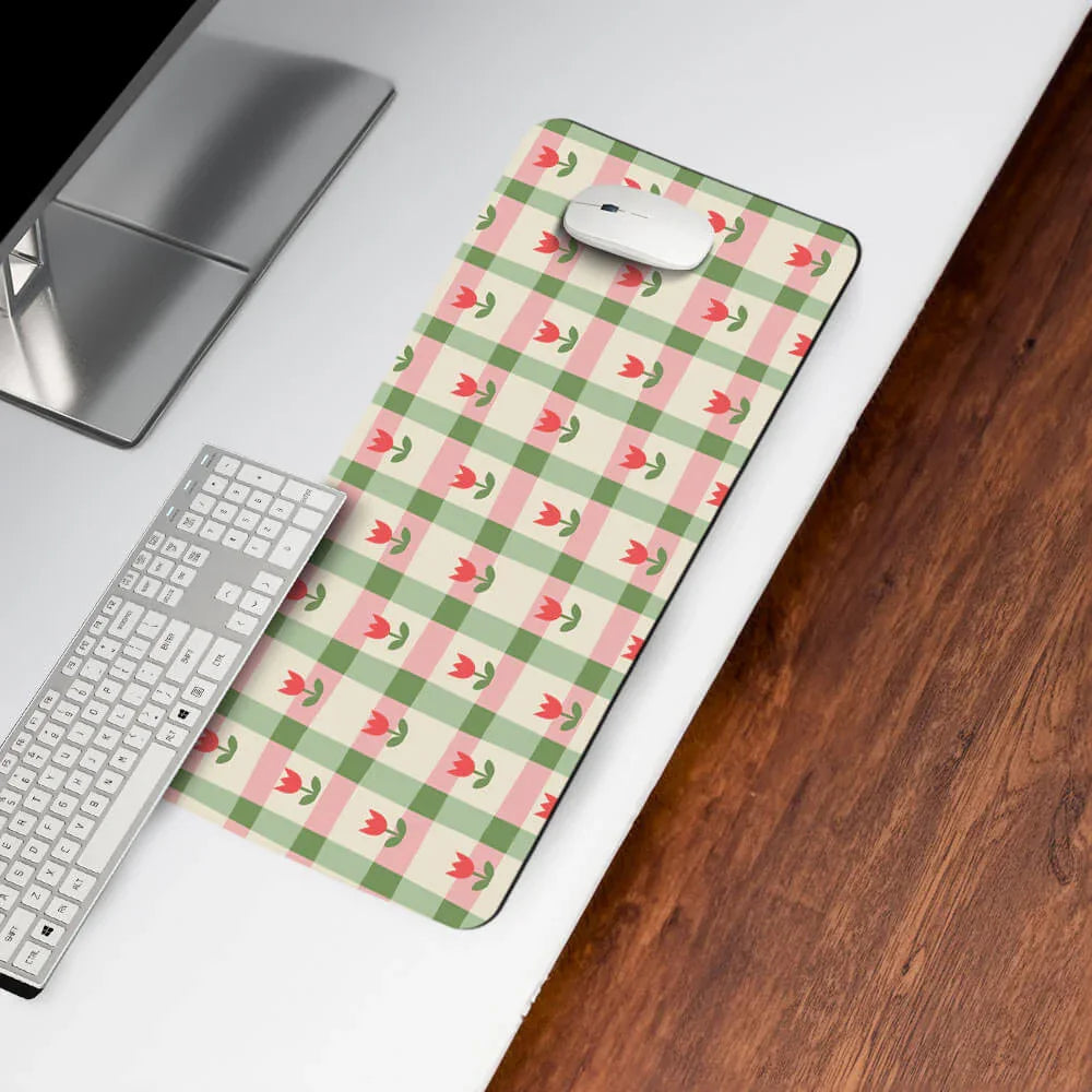 Floral checkered desk mat with pink tulip design on a white office desk, keyboard and mouse