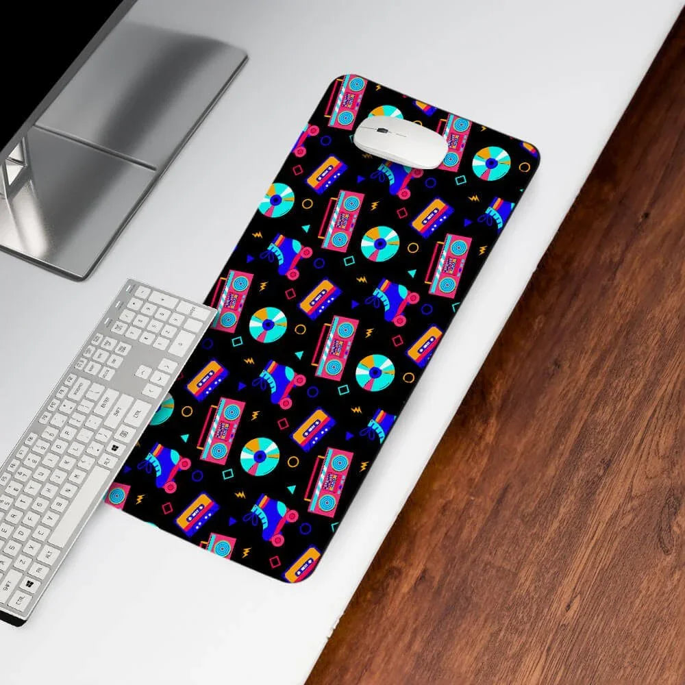 Colorful retro desk mat with cassette, boombox, roller skates on a computer desk