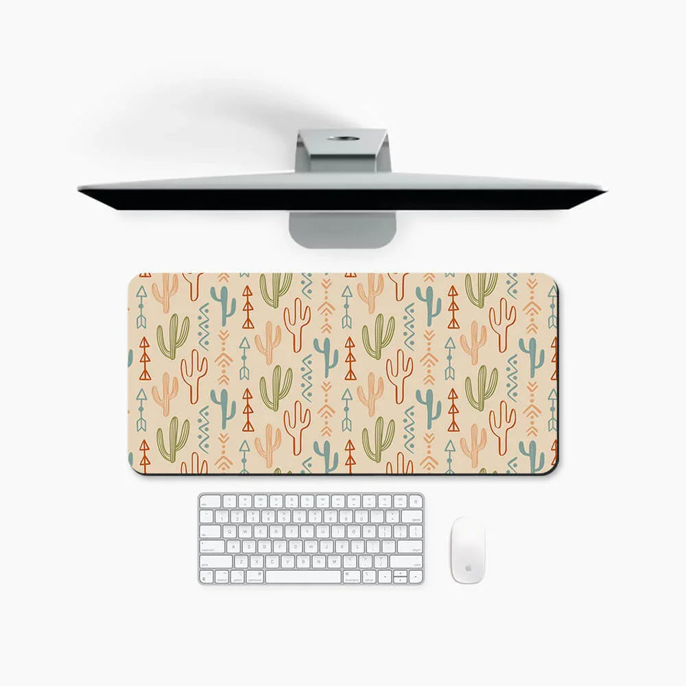 Large desk mat with colorful cactus and geometric patterns, shown with keyboard and monitor