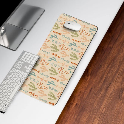Desk mat with colorful cactus and arrow pattern on modern office desk beside keyboard and mouse